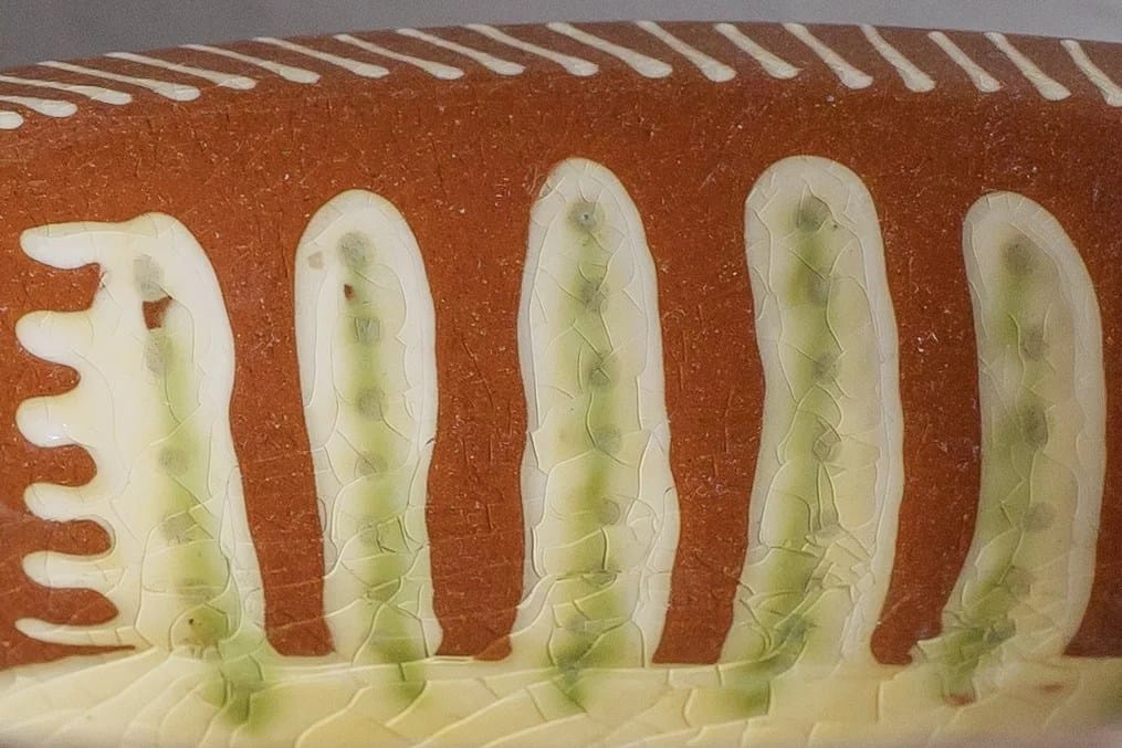 A close-up of a red dish with a pattern on, in close-up photography portfolio