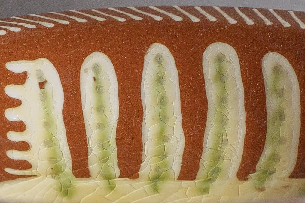 A close-up of a red dish with a pattern on, in close-up photography portfolio