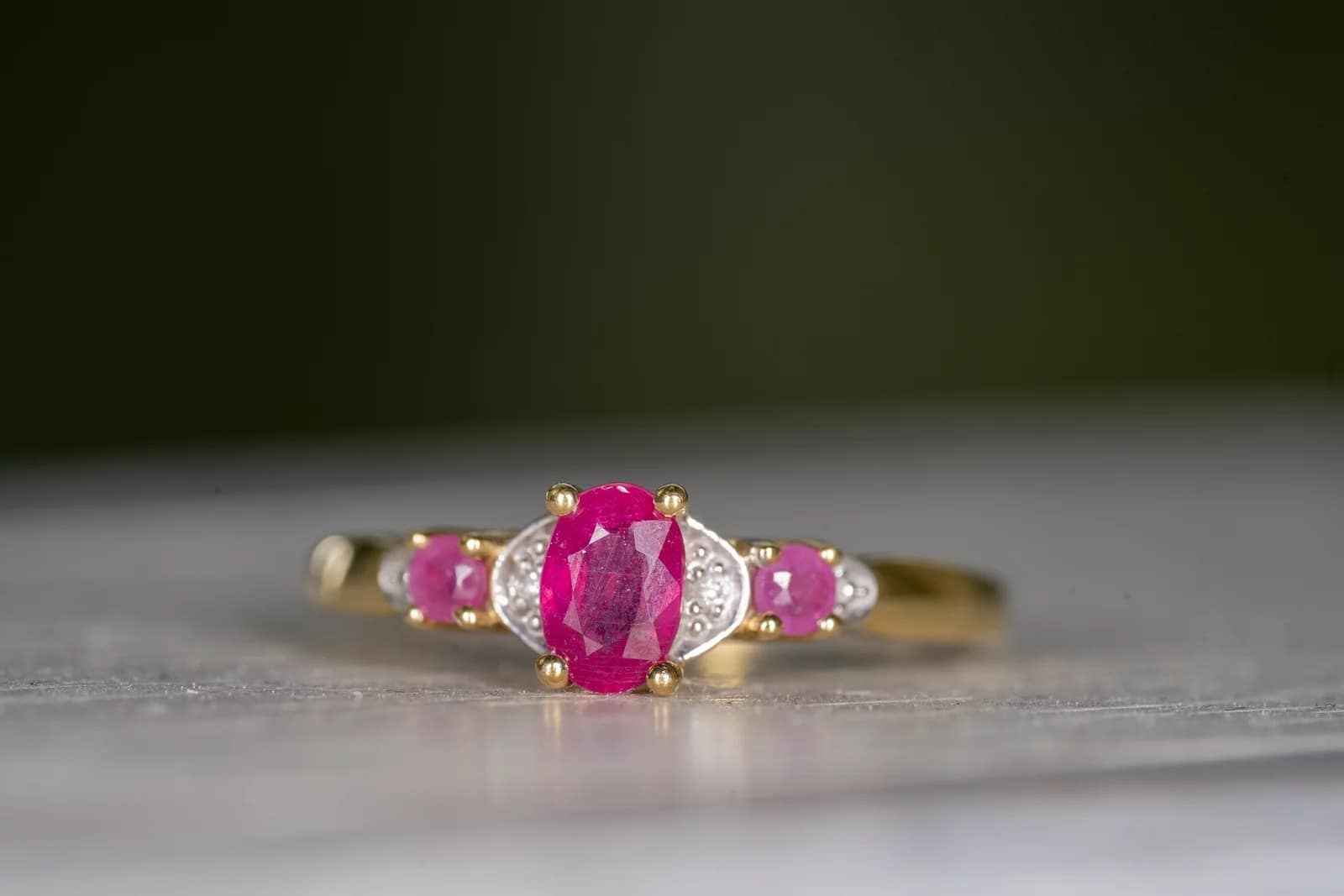 A ruby ring on a plain surface, close-up photography portfolio