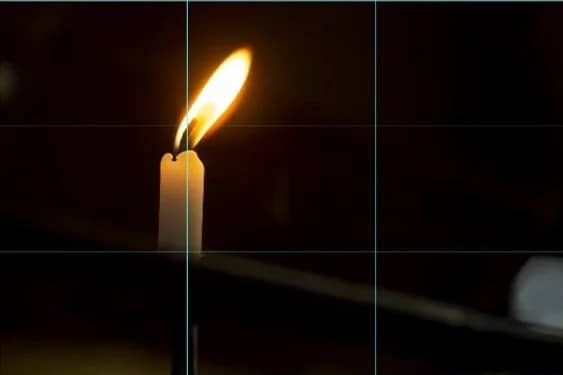 Lit candle in the dark