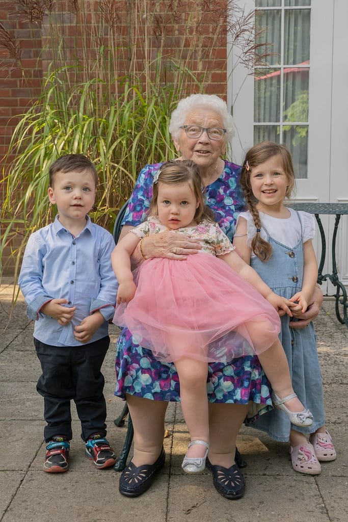 A grandma with her three grandchildren, in family photography portfolio