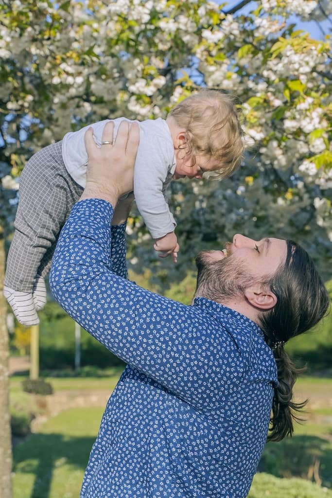 A dad holding his son in the air