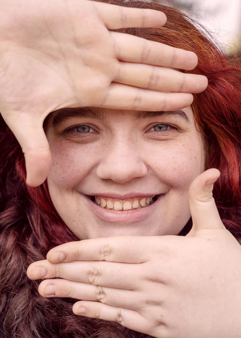 A woman framing her face with her hands
